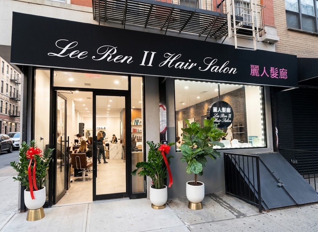 Lee Ren II Hair Salon storefront lit up at night on Broome St, New York